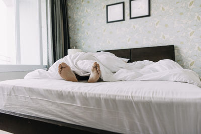 Man relaxing on bed