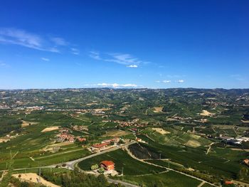 Aerial view of agricultural field against blue sky