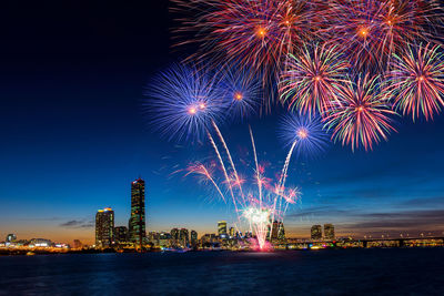 Low angle view of firework display at night