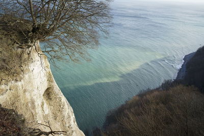 High angle view of sea and mountains against sky