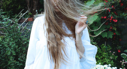 Close-up of woman against plants