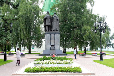 Rear view of people walking in park
