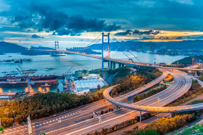 High angle view of bridge over road against cloudy sky