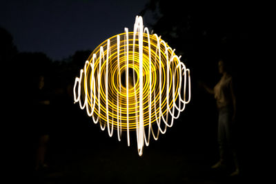 Low angle view of light painting at night