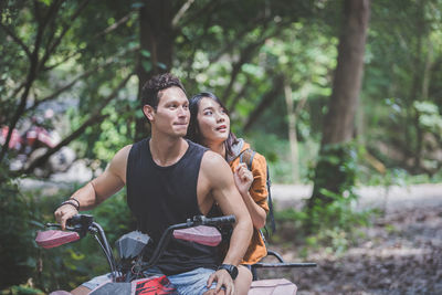 Young couple sitting outdoors