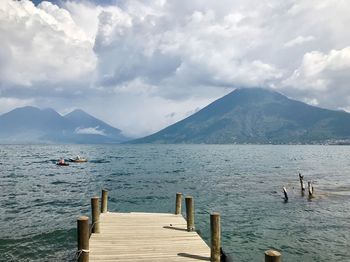 Scenic view of lake and mountains against sky