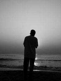 Rear view of man standing on beach