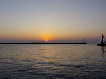 Scenic view of sea against orange sky