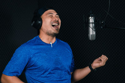 Midsection of man wearing mask at home