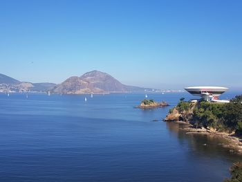 Scenic view of sea against clear blue sky