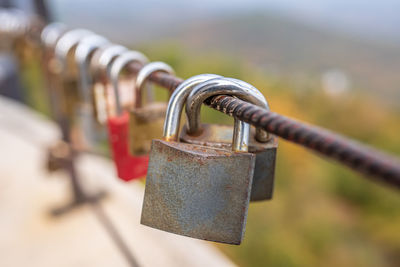 Close-up of padlocks on railing