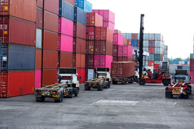 Vehicles on pier against buildings in city