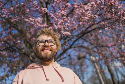 Low angle view of man standing against trees