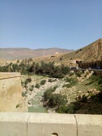 Scenic view of desert against clear blue sky