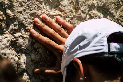 Close-up of man hand on rock