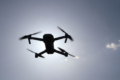 Low angle view of airplane flying against sky