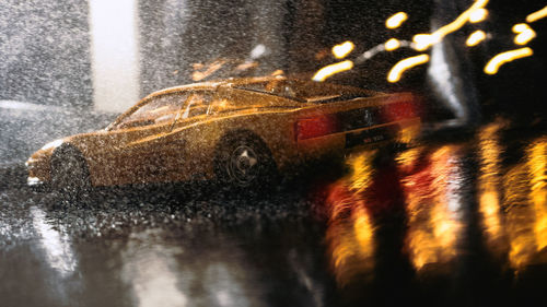 Blurred motion of wet car on street at night