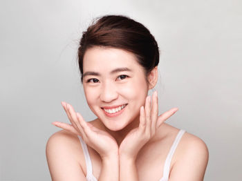 Portrait of a smiling young woman over white background