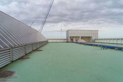 Bridge by buildings against sky