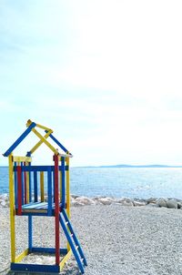 Lifeguard hut on beach against sky