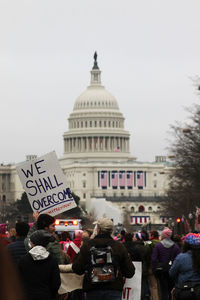 People in city against sky