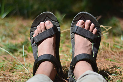 Low section of woman wearing shoes on field