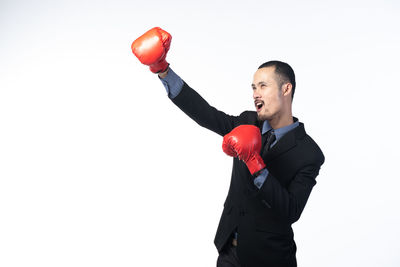 Full length of man standing against white background