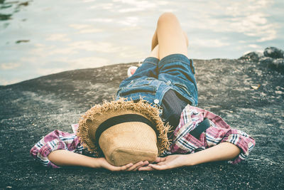 Woman lying down at lake