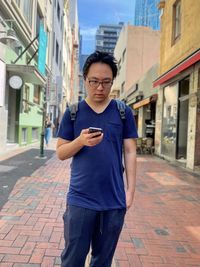 Portrait of young man standing on street