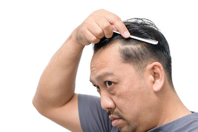 Close-up portrait of young man against white background