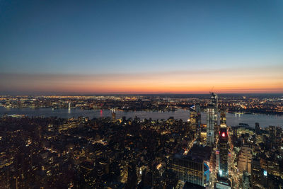 High angle view of city lit up at night