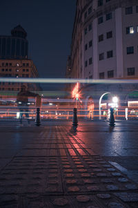 Illuminated light trails on road at night