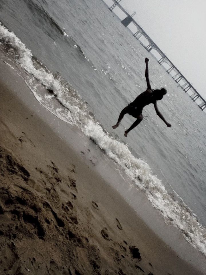 mid-air, sea, flying, beach, full length, jumping, leisure activity, silhouette, motion, lifestyles, extreme sports, wave, sand, shore, sport, water, nature, freedom