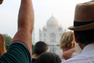 Rear view of people against building