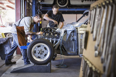 Mechanics repairing car at auto repair shop