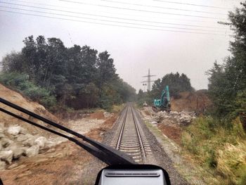 Railroad track seen through train windshield