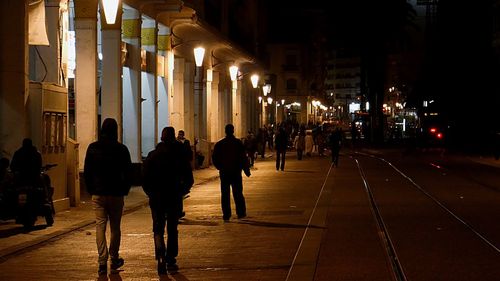 People on street in city at night