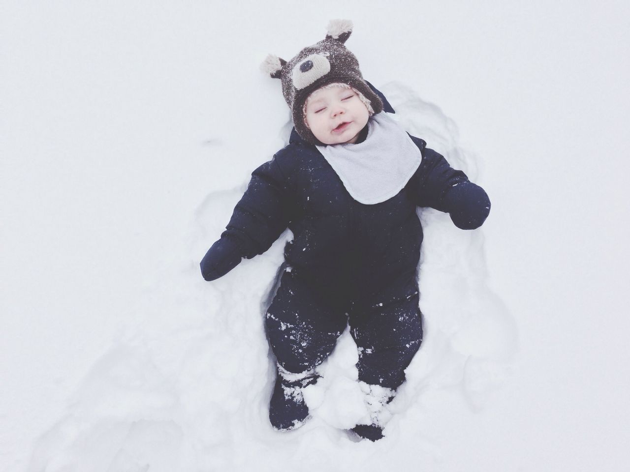 snow, winter, cold temperature, season, lifestyles, weather, leisure activity, warm clothing, looking at camera, covering, portrait, full length, person, white color, front view, young adult, standing, frozen