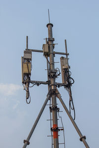 Low angle view of communications tower against sky