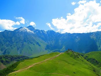 Scenic view of mountains against blue sky