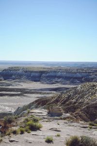 Scenic view of desert against clear blue sky