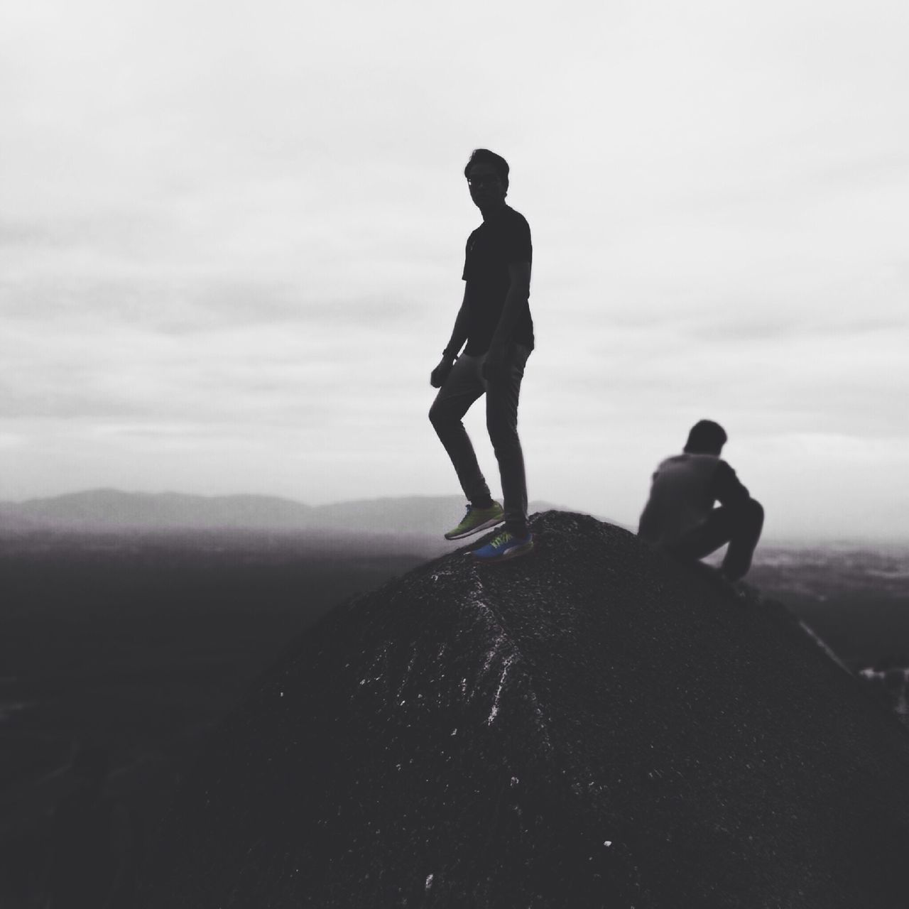 WOMAN STANDING ON MOUNTAIN