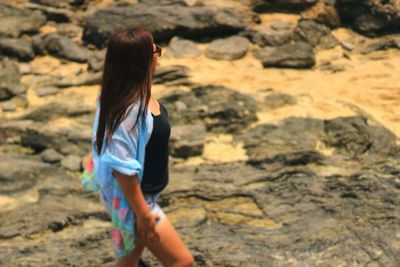 Profile view of woman standing on rock