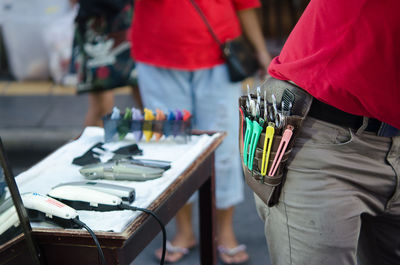 Midsection of barber with equipment