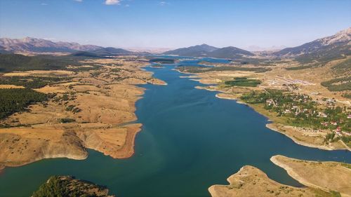 Scenic view of lake and mountains against sky