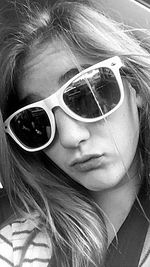 Close-up portrait of woman wearing sunglasses