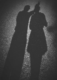 Shadow of man standing on road