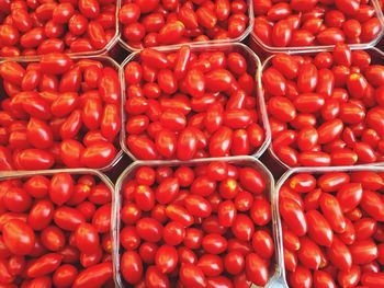 Full frame shot of cherry tomatoes in containers