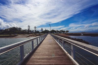 Pier over sea against sky