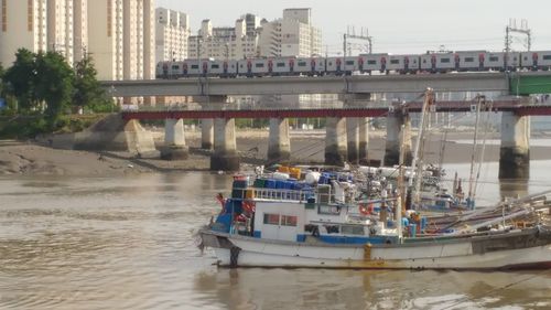 Boats in river with buildings in background